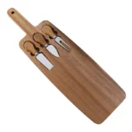 Acacia cheese board set with cheese knives and wooden cutting board on a table