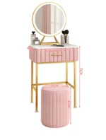 Marble top dressing table with lighted mirror and stool in a bedroom setting