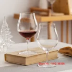 Kimura Shouko ultra thin wine glass on a wooden table, catching light