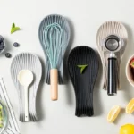 Silicone spoon rest holding a wooden spoon on a kitchen counter
