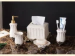 European-style white porcelain bathroom set on a glass shelf, with soft shadows.