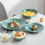Vancasso KARST green stoneware dinner set with embossed plates and bowls on a rustic wooden table
