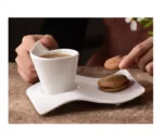 White porcelain espresso cup with wavy design on saucer, modern home decor