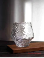 Set of hazy wine glasses with hammer pattern and snowflake design on a wooden table