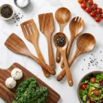 Set of teak wood cooking spoons on a wooden countertop