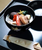 Japanese style ramen bowl set with melamine bowls, spoons, and noodle cups on a table