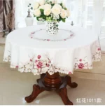 Elegant lace tablecloth with rose gold embroidery on a dining table