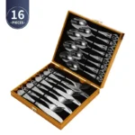Gold flatware set with spoon, fork, and steak knife on a white tablecloth
