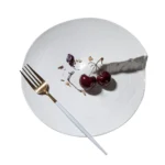 Hexagonal dinner plate with Japanese-inspired ceramic design on a wooden table