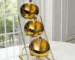 Set of stainless steel dipping bowls with golden rim on a wooden table