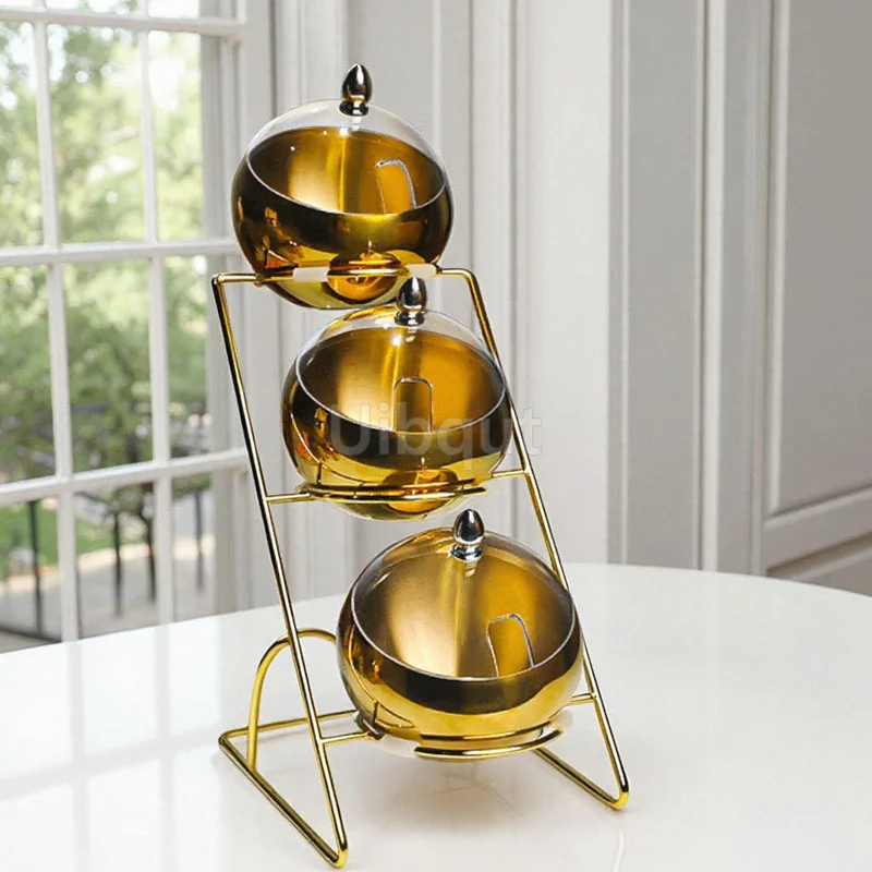 Set of stainless steel dipping bowls with golden rim on a wooden table