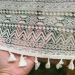 Retro polka dot tablecloth with fringe on a wooden table