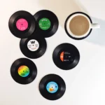 Set of vinyl record coasters on a wooden table