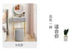 Marble top dressing table with lighted mirror and stool in a bedroom setting