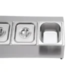 Stainless steel spice rack with 5 pans and lids on kitchen countertop