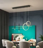 Gold chandelier with curved arms and glass shades in an elegant setting.
