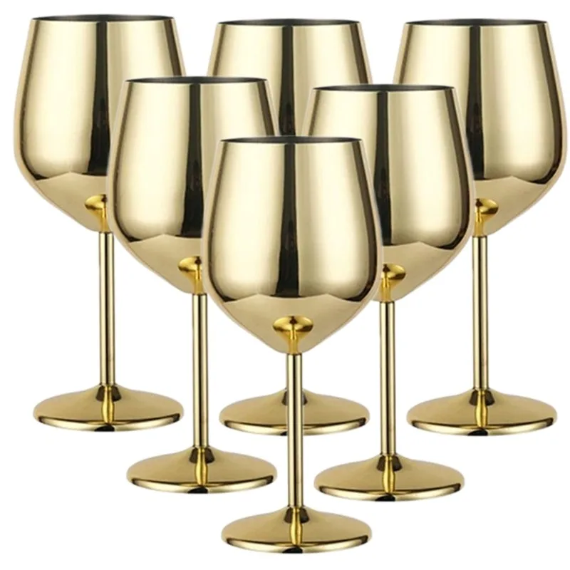 Set of 6 stainless steel wine glasses on a wooden table with red wine