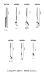 Stainless steel flatware set with ceramic pearl handles on wooden table
