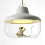 Round glass pendant light casting ambient light in a children's room, playful and safe design
