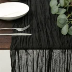 Rustic cheesecloth table runner on wooden table with boho decor