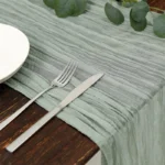 Rustic cheesecloth table runner on wooden table with boho decor
