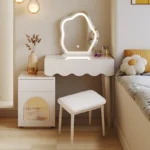 Modern makeup vanity desk with mirror and stool in a bedroom setting, showcasing ample storage and elegant design