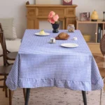 French country tablecloth with retro plaid pattern and lotus leaf edge on a dining table