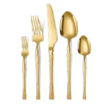 Goldoma stainless steel cutlery set with hammer pattern handles on a wooden table