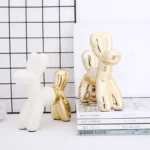 Ceramic saving pot shaped like a balloon dog on a nightstand.