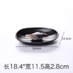 Black melamine dinner plates stacked elegantly on a wooden table