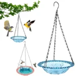 Hanging bird bath with a green metal chain and a shallow blue ceramic bowl in a garden setting.