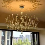 Modern stainless steel chandelier with crystal LED lights in a living room
