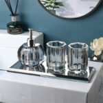 Set of two glass bottles with pumps, bathroom setting.
