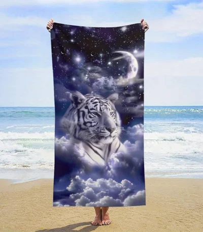 White tiger beach towel spread on sand by pool