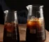 Conical glass coffee pot with hand-brewed coffee dripping into the pot, showcasing its sleek design and measuring marks