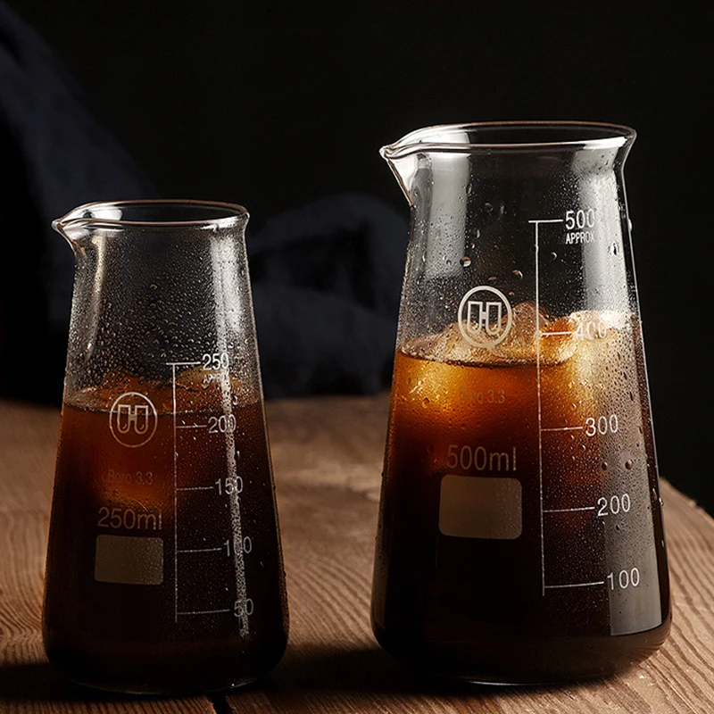 Conical glass coffee pot with hand-brewed coffee dripping into the pot, showcasing its sleek design and measuring marks