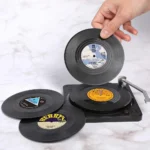 Set of vinyl record coasters on a wooden table