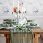 Boho cheesecloth table runner and napkins set as rustic table linens on a wooden table