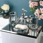 Clear glass lotion bottle with pump dispenser on bathroom counter.