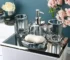 Clear glass lotion bottle with pump dispenser on bathroom counter.