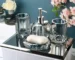 Clear glass lotion bottle with pump dispenser on bathroom counter.