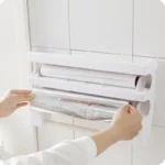 Goldoma wall mounted paper towel holder with storage rack and cutter in a modern kitchen