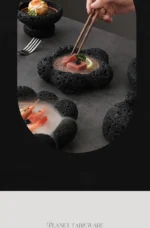 Volcanic stone sushi plate with fresh sushi rolls and wasabi on a dark textured surface