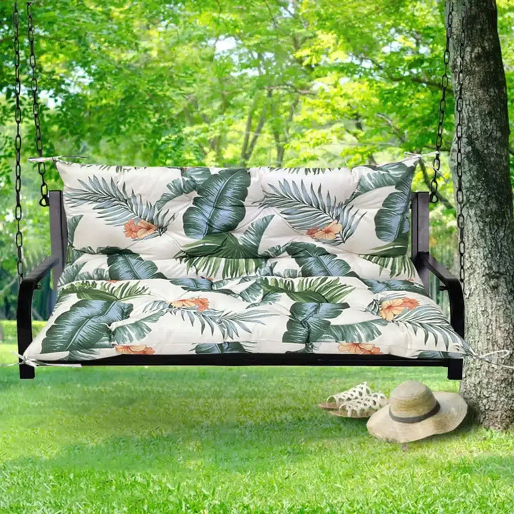 Outdoor bench cushion on a wooden garden bench with vibrant floral pattern