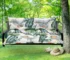 Outdoor bench cushion on a wooden garden bench with vibrant floral pattern