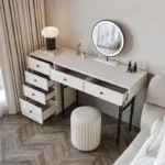 Modern minimalist makeup vanity table with mirror and stool in a bedroom setting