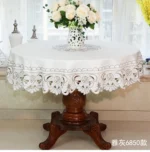 Elegant lace tablecloth with rose gold embroidery on a dining table
