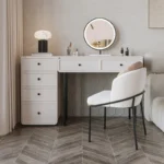 Modern minimalist makeup vanity table with mirror and stool in a bedroom setting