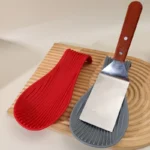 Silicone spoon rest holding a wooden spoon on a kitchen counter
