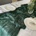Rustic cheesecloth table runner on wooden table with boho decor